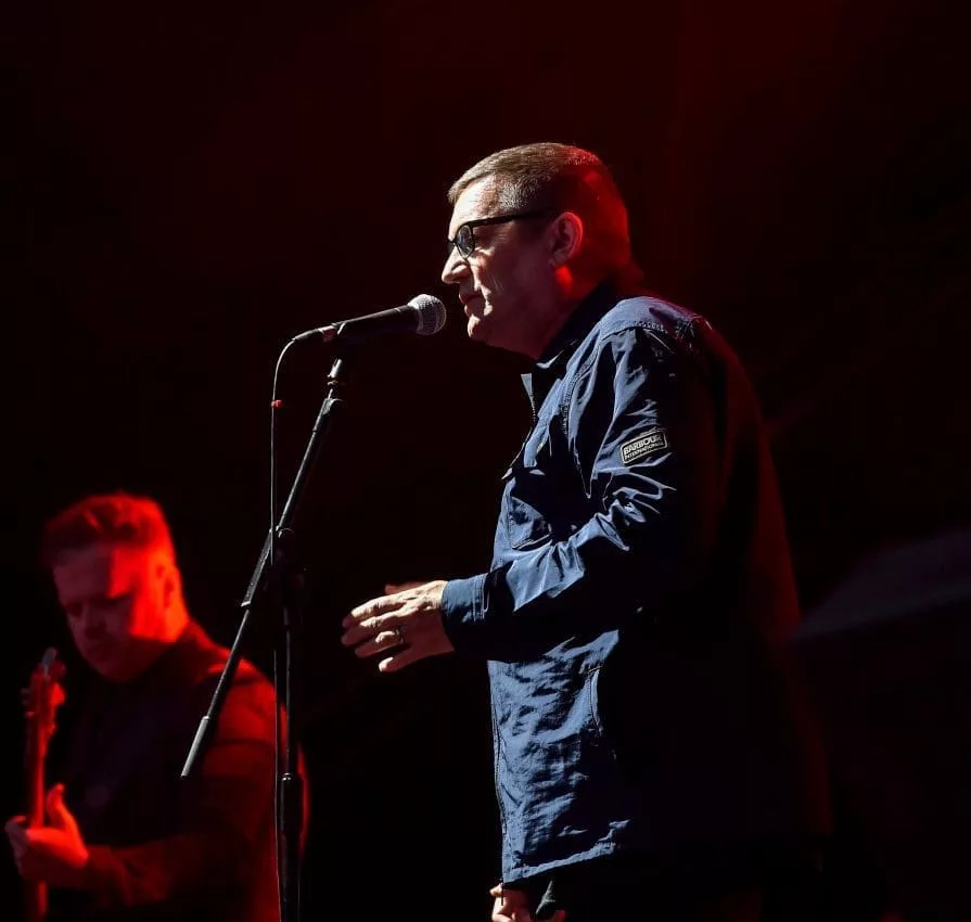 man singing on stage