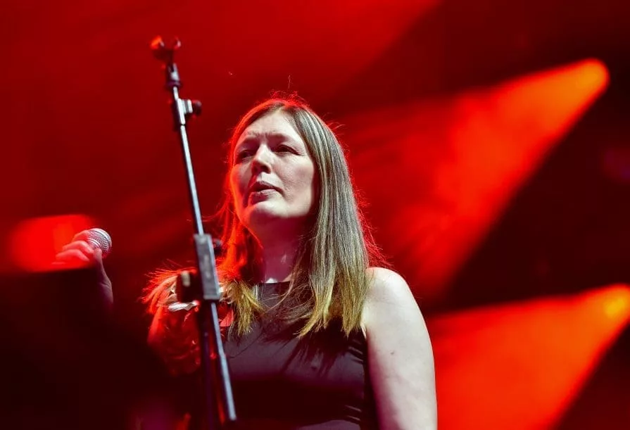 lady on stage with red background