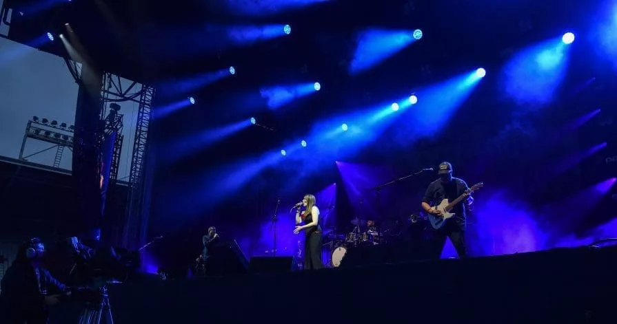 band on stage with blue lights