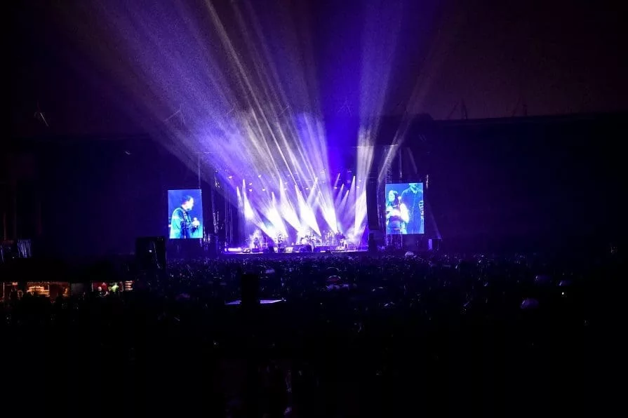 stage with two screens and blue lights