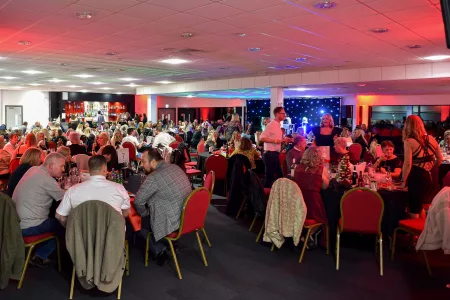 wide shot of people at event sat at tables